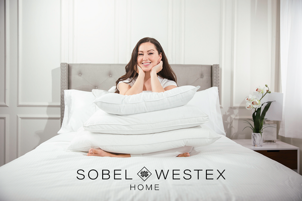 woman with elbows on stack of best feather pillows from Standard to King size