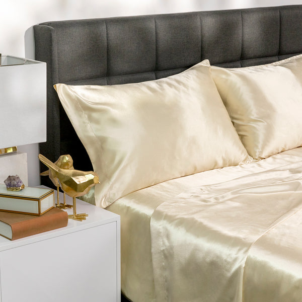 Picture of ivory satin bed sheets on a bed