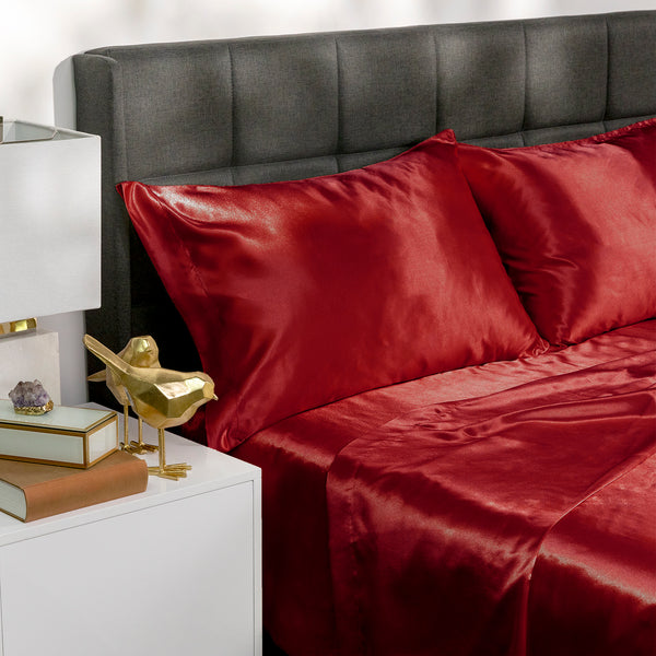 Picture of red satin bed sheets on a bed