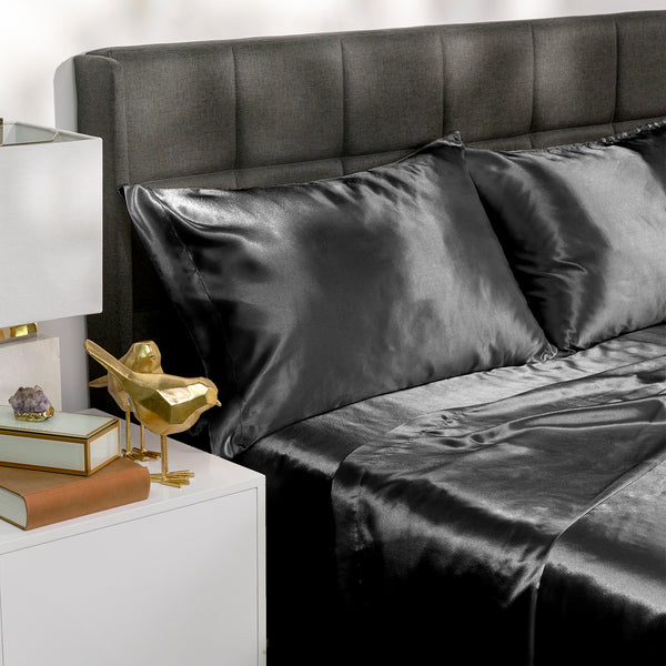 Picture of black satin bed sheets on a bed