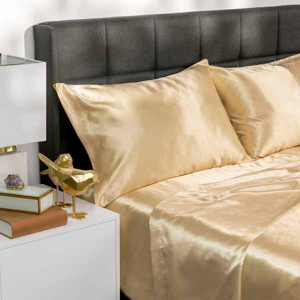 Picture of gold satin bed sheets on a bed